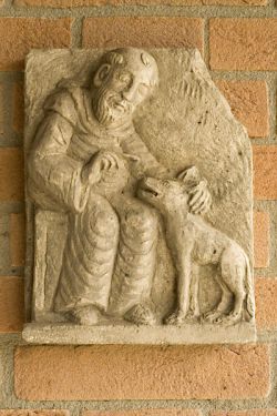 Francis of Assisi and the wolf, stone carving